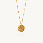 Gold-plated sterling silver chain necklace featuring a round, textured disc pendant with a small white sapphire set in the center.