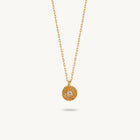 Gold-plated silver chain necklace featuring a round, textured disc pendant with a small white sapphire set in the center.