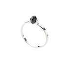 Gold ring with a black faceted diamond on a white background