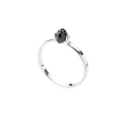 Gold ring with a black faceted diamond on a white background