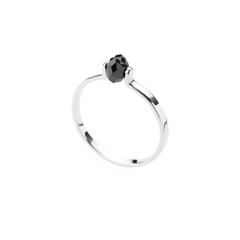 Gold ring with a black faceted diamond on a white background