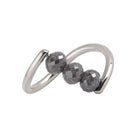 A white gold ring featuring three faceted dark gray diamond beads set along a curved, open infinity-style band, shown on a plain white background.