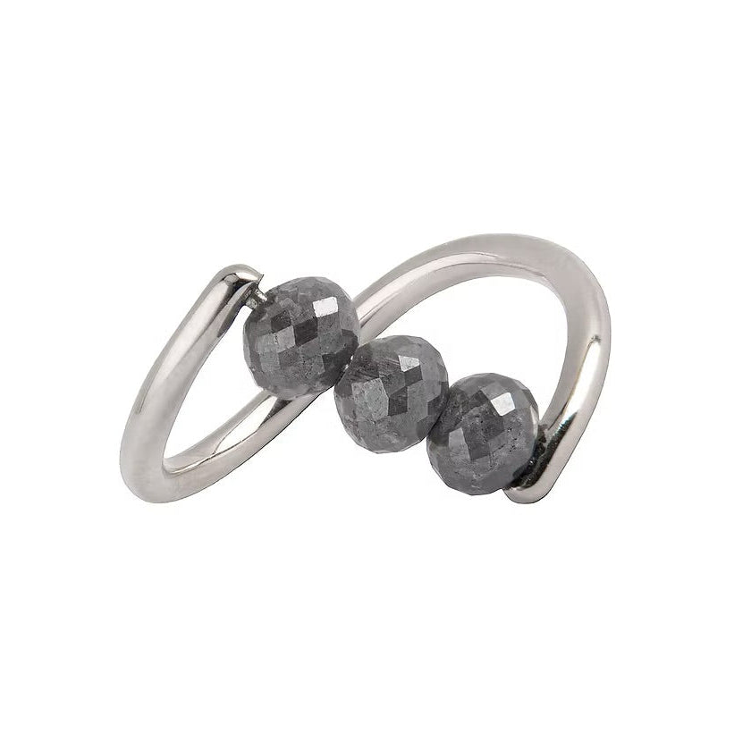 A white gold ring featuring three faceted dark gray diamond beads set along a curved, open infinity-style band, shown on a plain white background.