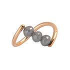 A rose gold ring featuring three faceted dark gray diamond beads set along a curved, open infinity-style band, shown on a plain white background.