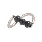 A white gold ring featuring three faceted dark gray diamond beads set along a curved, open infinity-style band, shown on a plain white background.