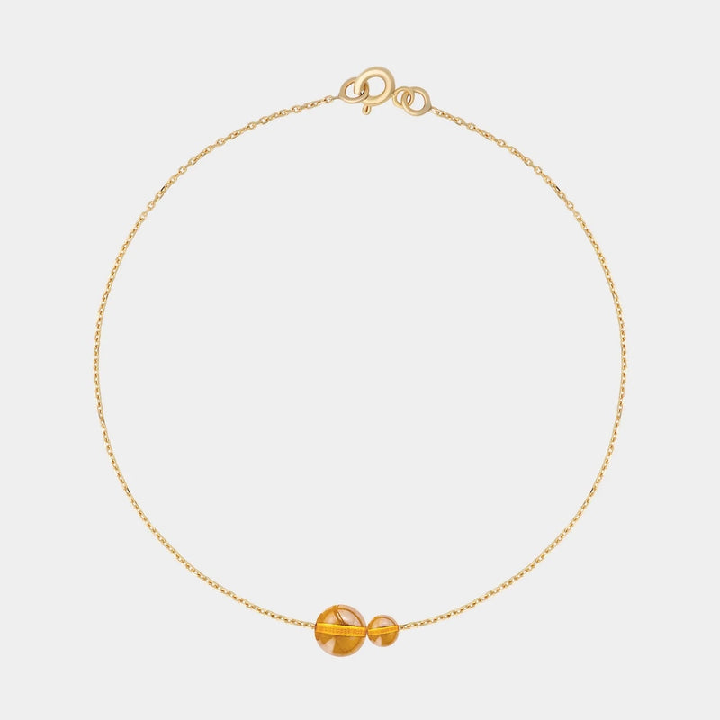 Gold bracelet with two asymmetrical Baltic ambers by Adele Notes.