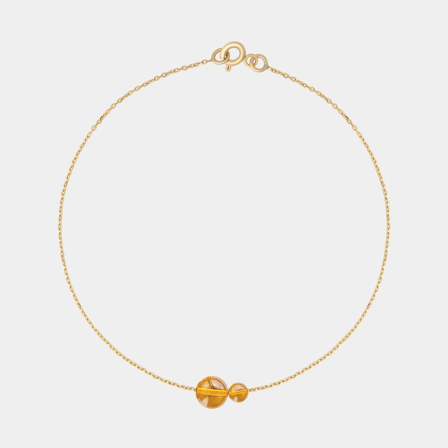 Gold bracelet with two asymmetrical Baltic ambers by Adele Notes.