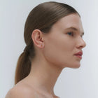 Silver earrings by Adele Notes, featuring a band and small Baltic amber element.