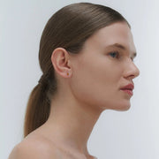 Silver earrings by Adele Notes, featuring a band and small Baltic amber element.