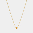 Gold necklace with small Baltic amber pendant by Adele Notes.