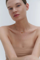 Gold necklace with two asymmetrical Baltic amber pendants by Adele Notes. 