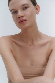 Gold necklace with two asymmetrical Baltic amber pendants by Adele Notes. 