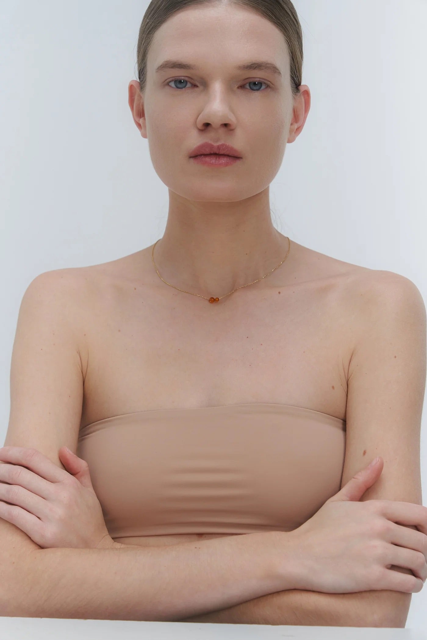 Gold necklace with two asymmetrical Baltic amber pendants by Adele Notes. 
