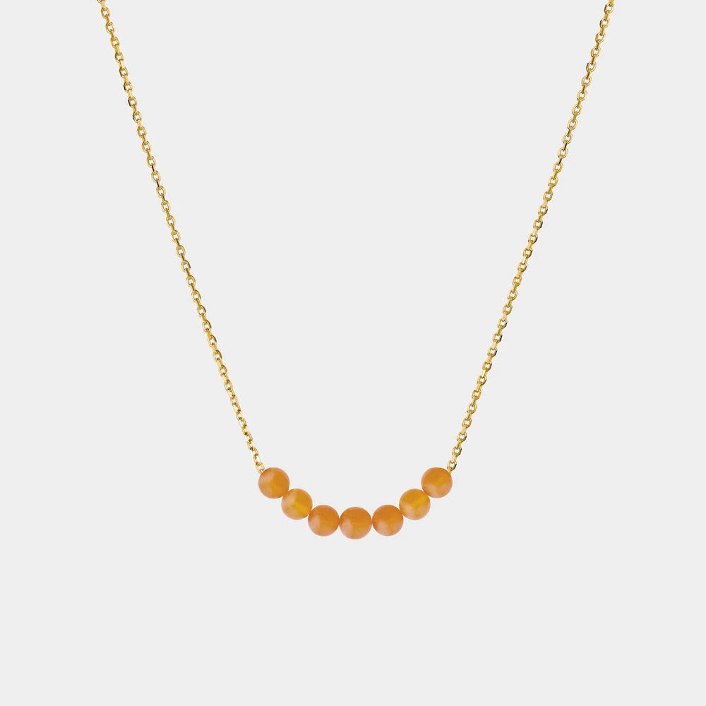 Necklace with Baltic amber beads on a white background