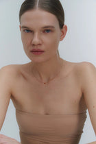 Gold necklace with small Baltic amber pendant by Adele Notes.