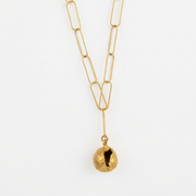 Gold necklace with a unique pendant on a white background