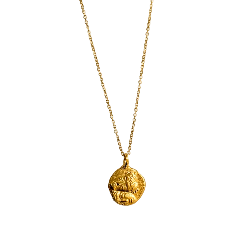 24kt gold-plated coin pendant with faces.