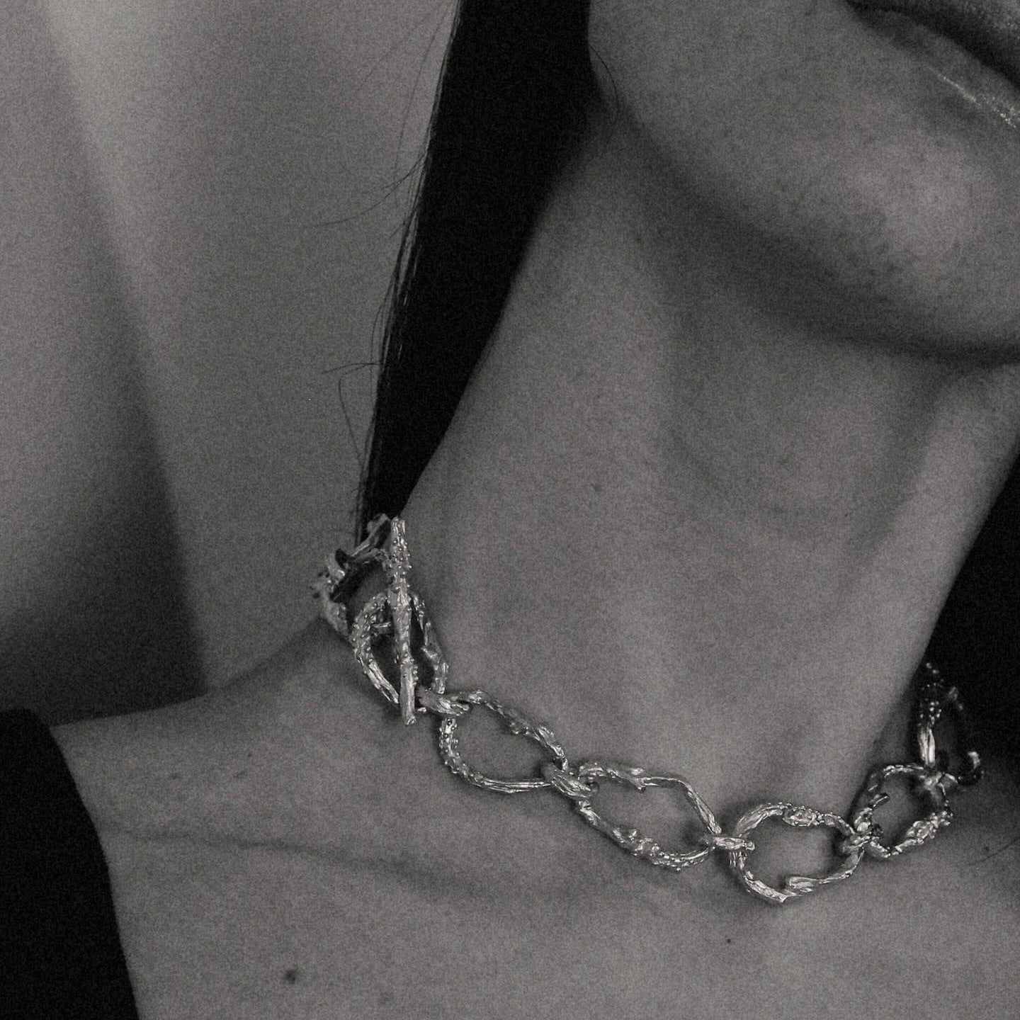 Gold-plated bronze necklace featuring an organic chain of irregular, textured links with a molten-inspired finish.