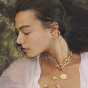 Gold-plated bronze necklace featuring an organic chain of irregular, textured links with a molten-inspired finish.