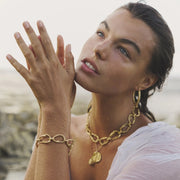 Gold-plated bronze necklace featuring an organic chain of irregular, textured links with a molten-inspired finish.