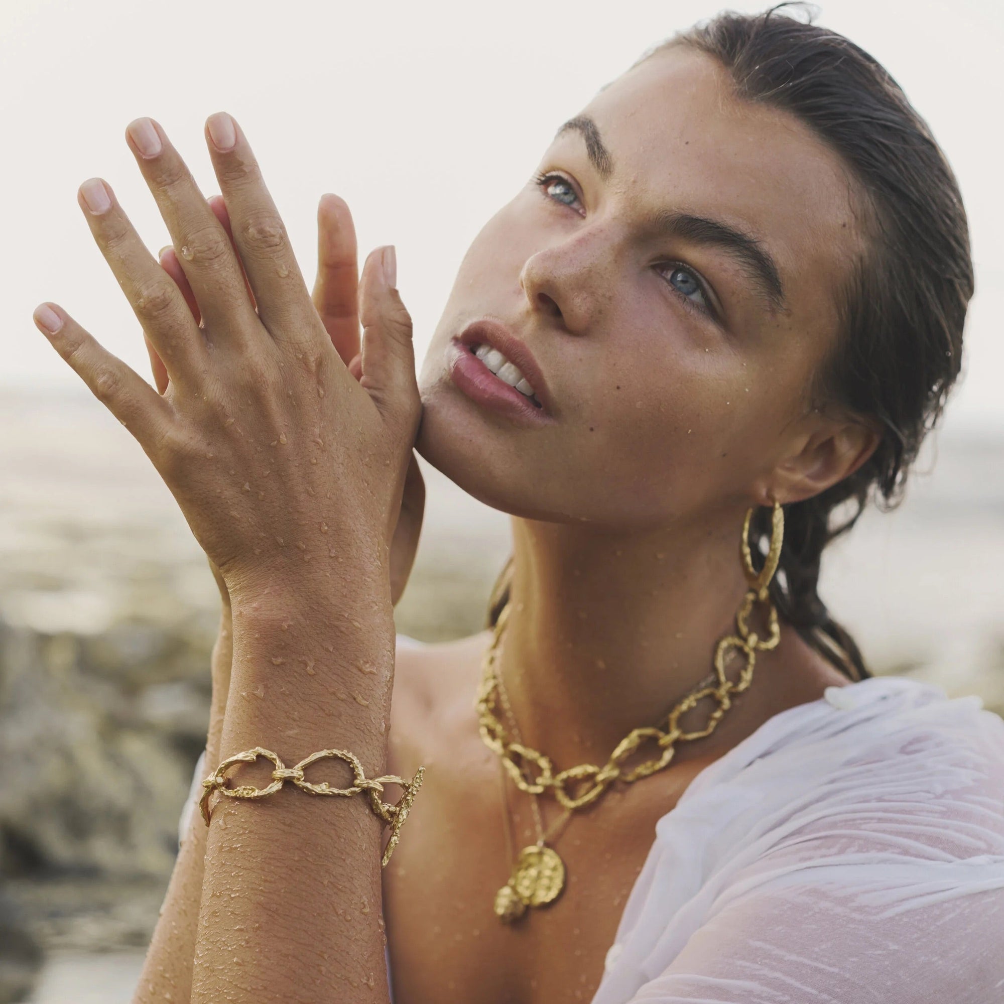 Gold-plated bronze necklace featuring an organic chain of irregular, textured links with a molten-inspired finish.