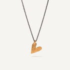 Gold heart-shaped pendant on a black chain against a white background