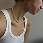 Woman wearing a freshwater pearls & gold necklace