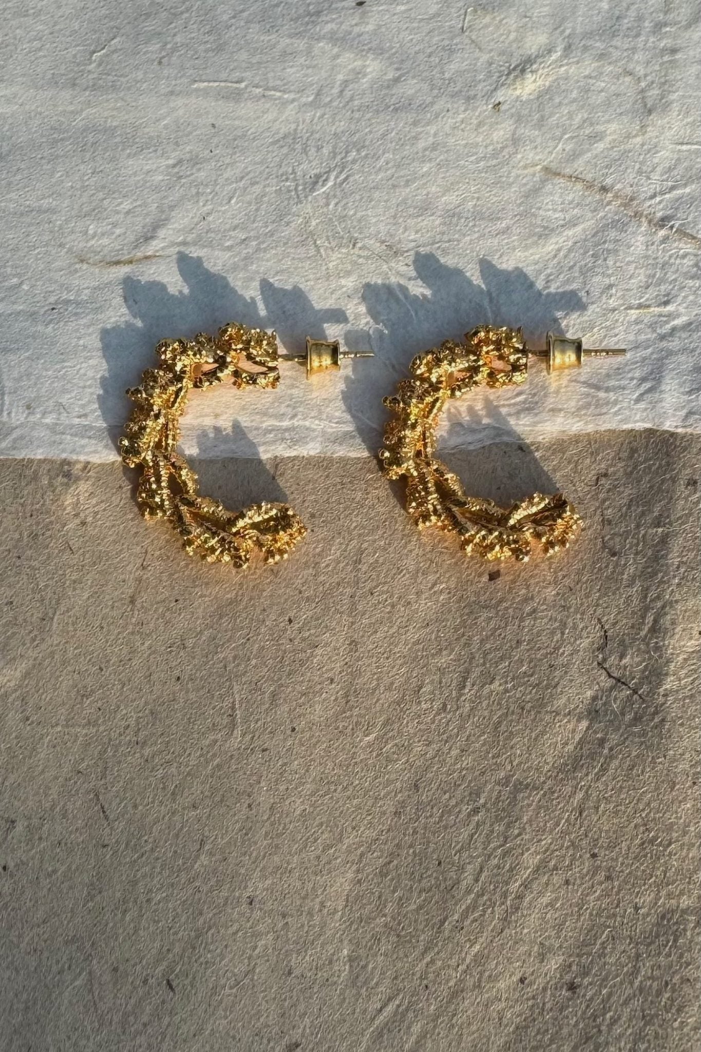 Gold-plated silver hoop earrings with an organic, coral reef inspired texture.