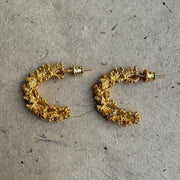 Gold-plated silver hoop earrings with an organic, coral reef inspired texture.