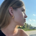 Gold-plated silver hoop earrings with an organic, coral reef inspired texture.