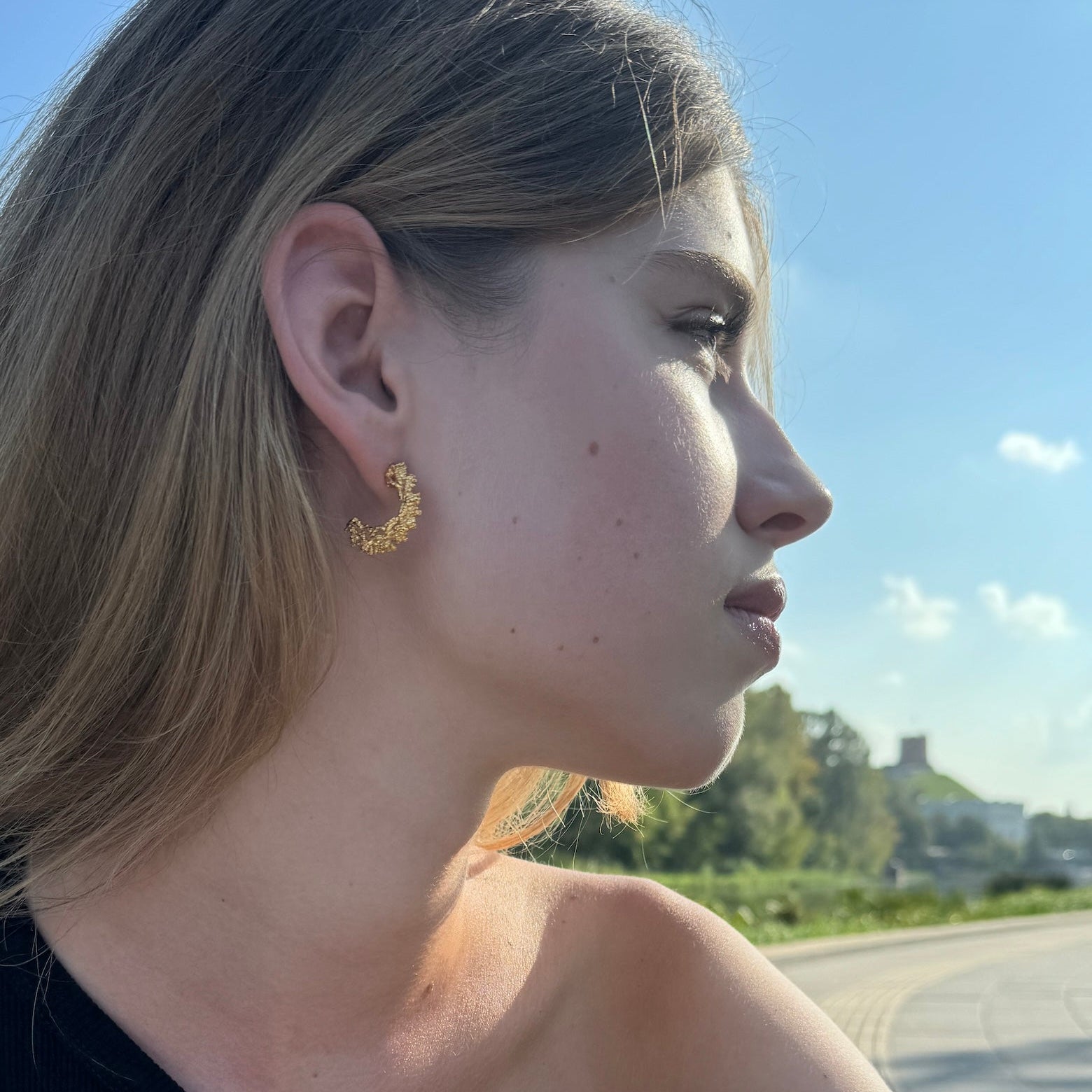 Gold-plated silver hoop earrings with an organic, coral reef inspired texture.