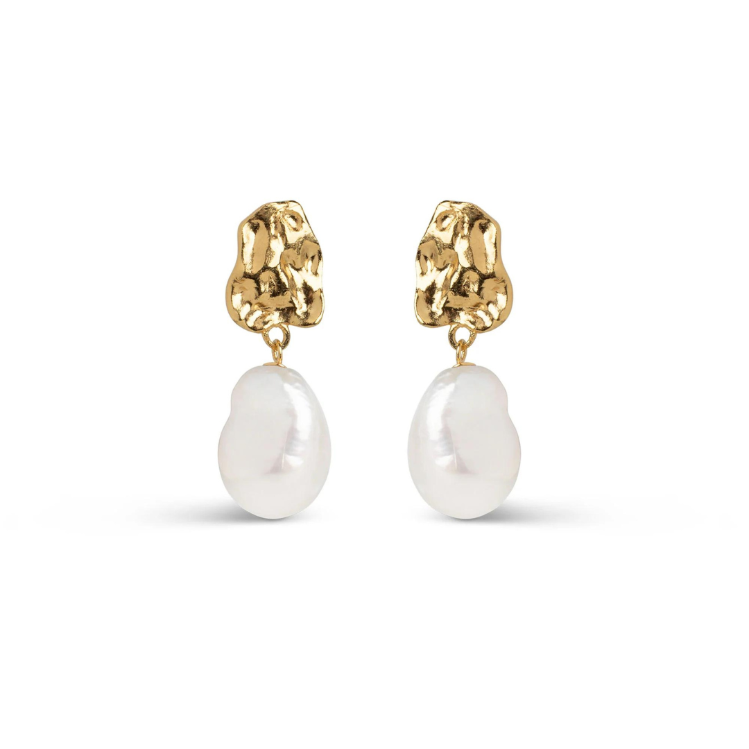 A pair of gold-plated silver earrings featuring a large, wavy stud and a baroque freshwater pearl attached to it.