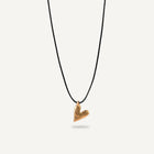 A gold plated silver necklace with a heart-shaped pendant on a black string.