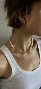 Person wearing a pearl necklace
