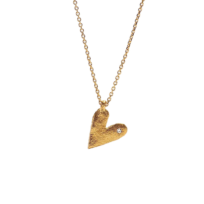 Gold heart-shaped pendant necklace on a white background