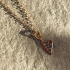 A gold plated silver necklace featuring a heart-shaped pendant with sapphires.