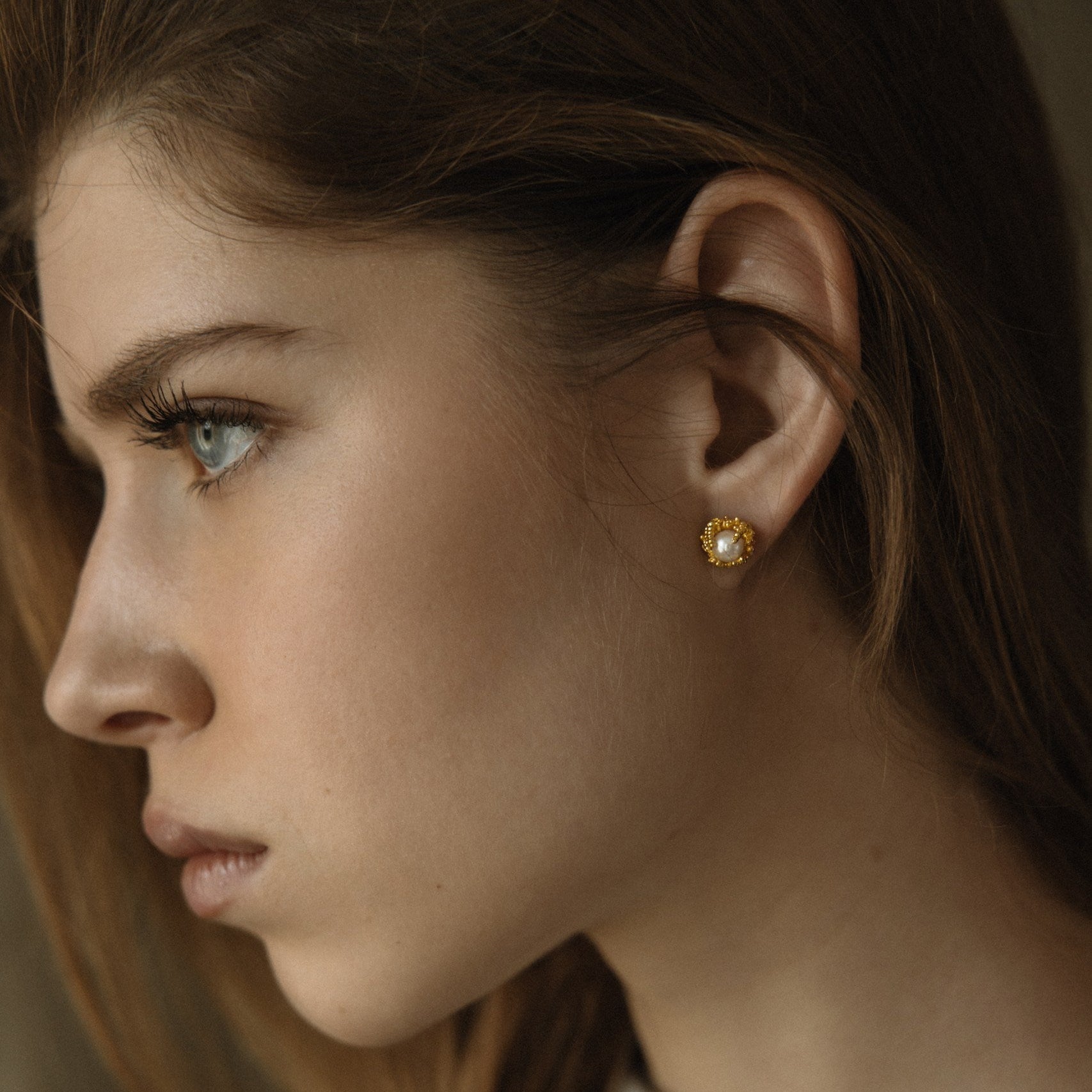 Gold-plated silver earrings set with Akoya pearls. 