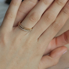 Hand wearing gold & diamonds band with word Mama by Formes.