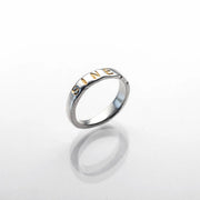 Polished sterling silver ring with Latin inscription, featuring a smooth band with engraved text.
