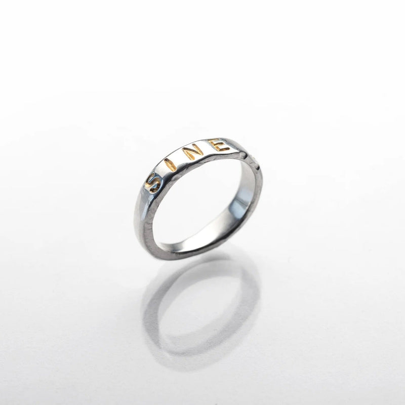 Polished sterling silver ring with Latin inscription, featuring a smooth band with engraved text.
