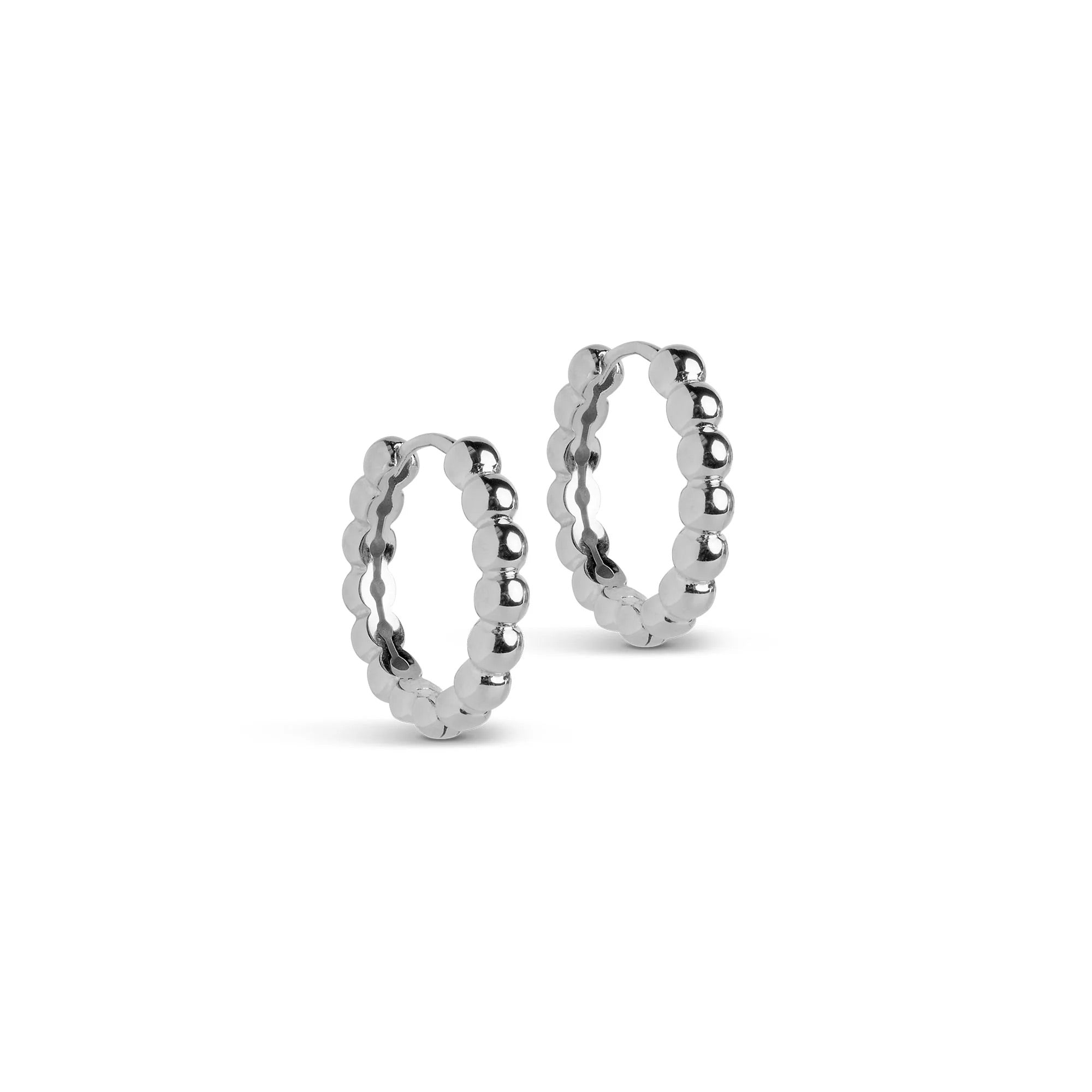 A pair of large silver hoop earrings with a ball pattern texture, displayed against a white background