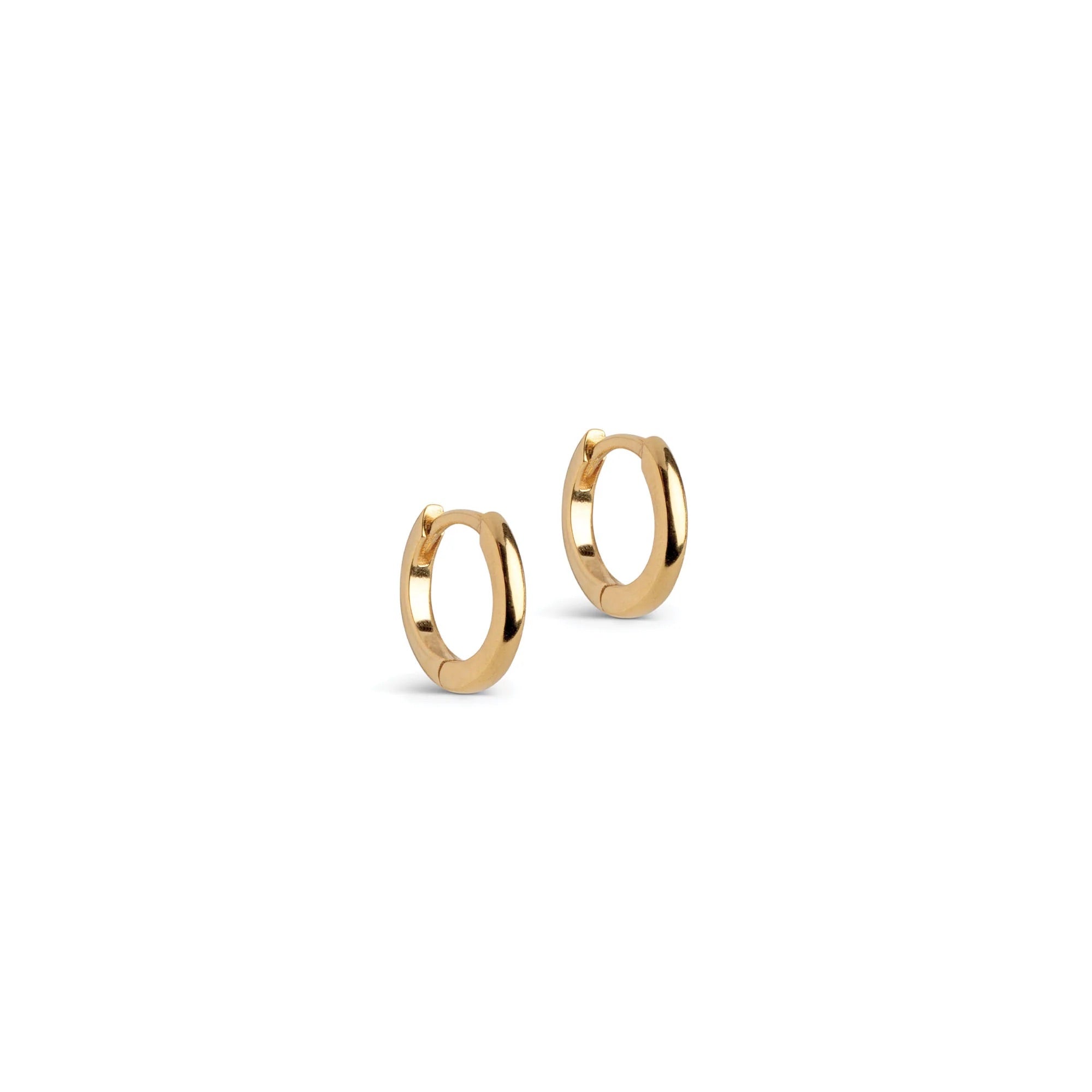 A pair of small gold huggie hoop earrings on a clean white background.