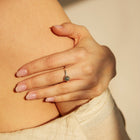 Hand with a ring on a beige background