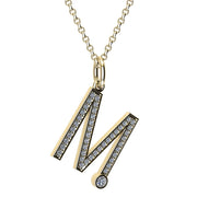 Gold and diamond necklace with letter 'M' pendant on a white background