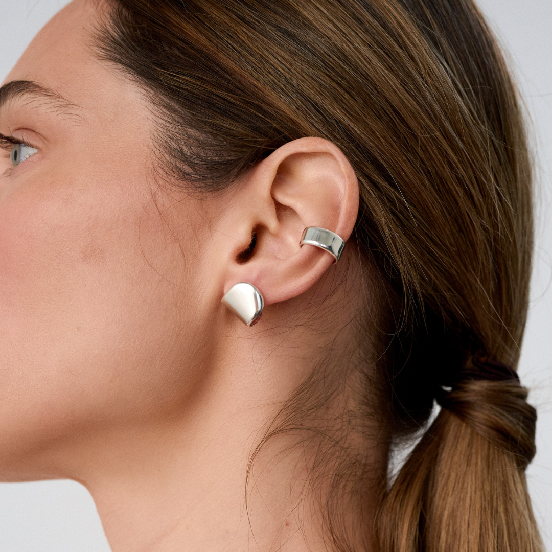 Woman wearing Miutto silver earrings.