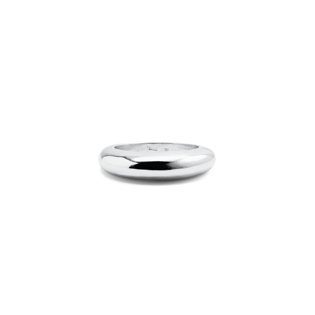 Minimalist polished silver ring with a smooth, rounded silhouette.