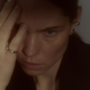 Woman wearing a minimalist polished silver ring with a smooth, rounded silhouette.