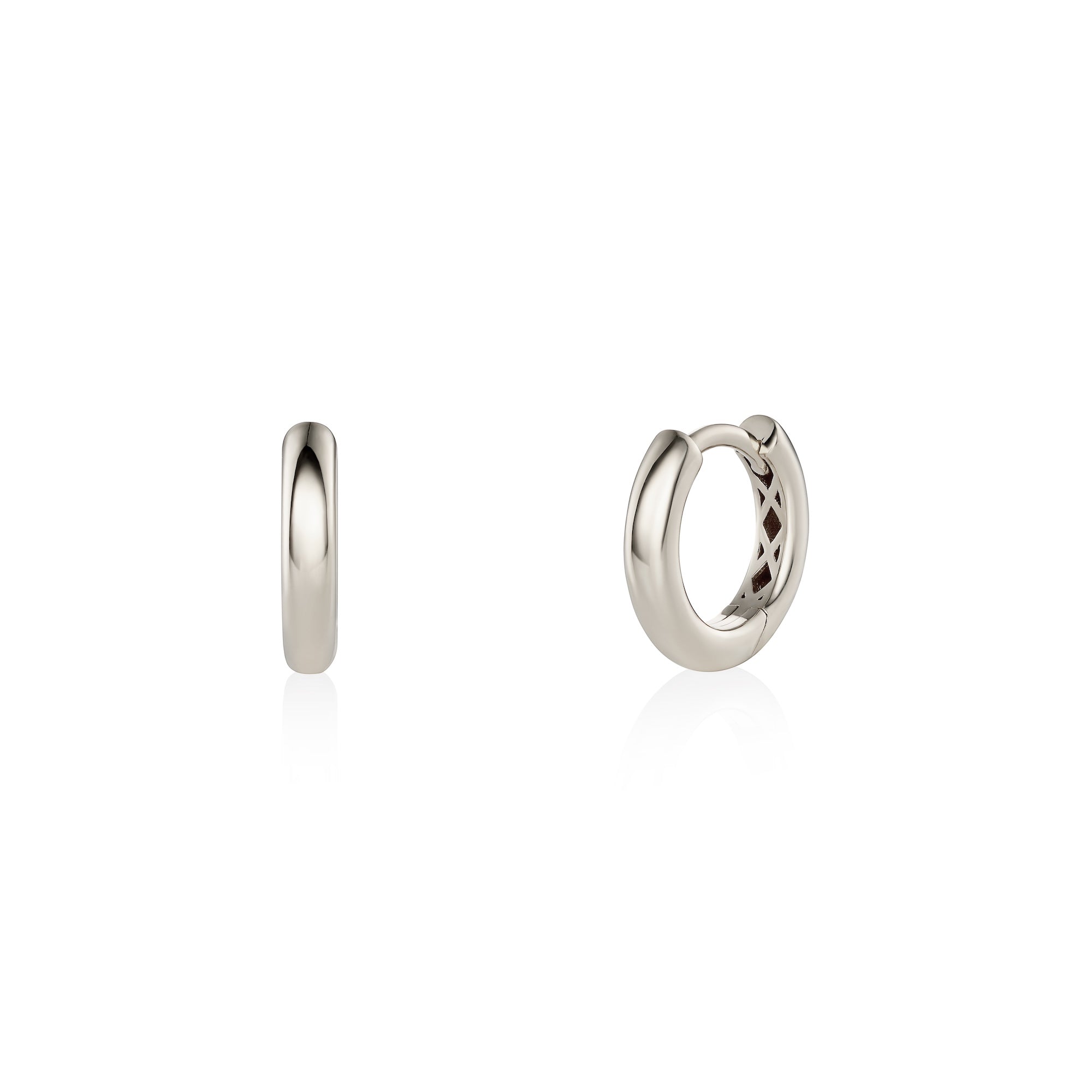 Pair of white gold hoop earrings on a white background