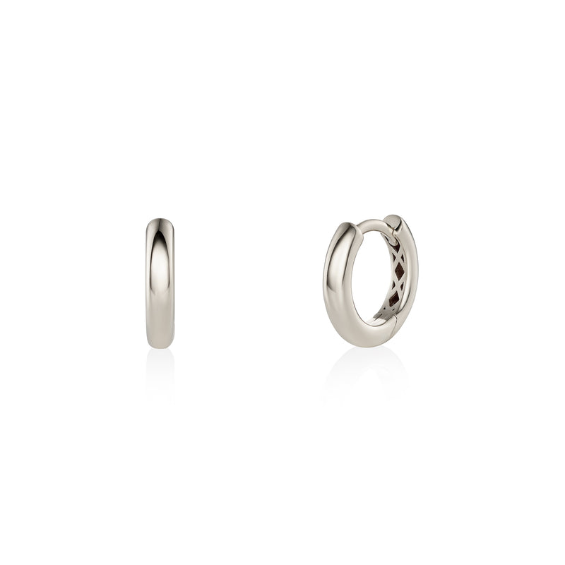 Pair of white gold hoop earrings on a white background