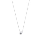 White gold pendant featuring a round brilliant-cut diamond, suspended from a delicate gold chain. 